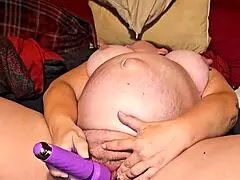 A big-busted mature woman orgasms while Masturbating
