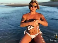 MILF taking a nude stroll with friends in the beach. Guys can't resist her beauty