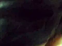 Older woman applying the strap on during the hotel/ sandal scene