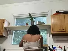 A latina mature woman enjoying house hold chores