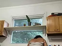 A latina mature woman enjoying house hold chores