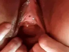 A shaved and mature woman pleases herself by fingering and rubbing her pussy