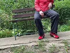 hey, watch this hot milf jerk a huge dick into a glass at the park bench