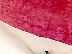 A mature woman is sliding her pussy, showcasing its wetness