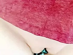 A mature woman is sliding her pussy, showcasing its wetness