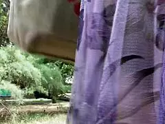 A hot hairy mature woman in a see-through dress is not shy to show off