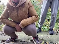 A fat curvy woman squats, urinates in public