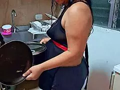 This horny Latina stepmom squirts in the kitchen while teasing her stepson.