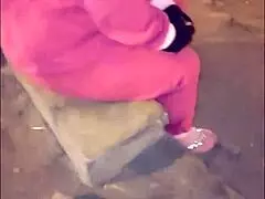 Look at this mature prostitute in costume, banging her raw on the street!