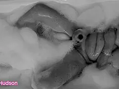 Kity Hudson strips down in the bath, grabs a toy, and works her hairy pussy hard. Curvy mature amateur hits orgasm fast.