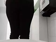 hidden camera in public bathroom captures clothing store employee unaware.